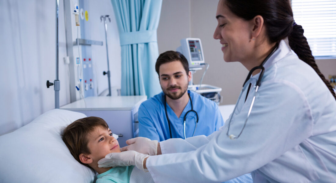 Doctors examining patient in ward at hospital Doctors examining patient in ward at hospital