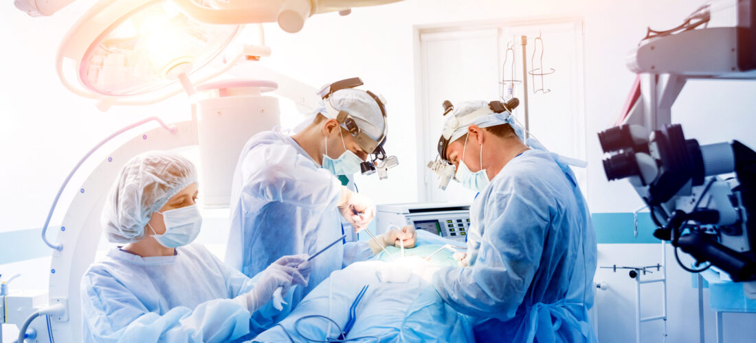 Spinal surgery. Group of surgeons in operating room with surgery equipment. Laminectomy. Modern medical background