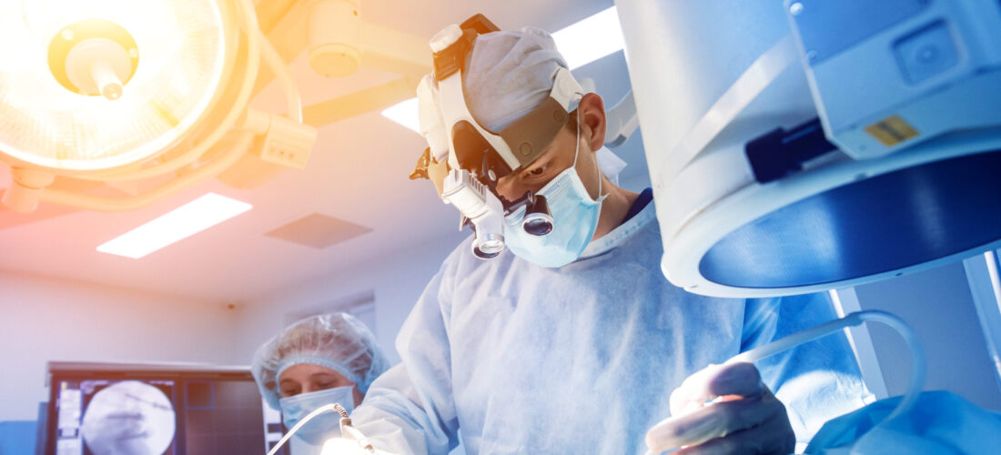 Spinal surgery. Group of surgeons in operating room with surgery equipment. Laminectomy. Modern medical background