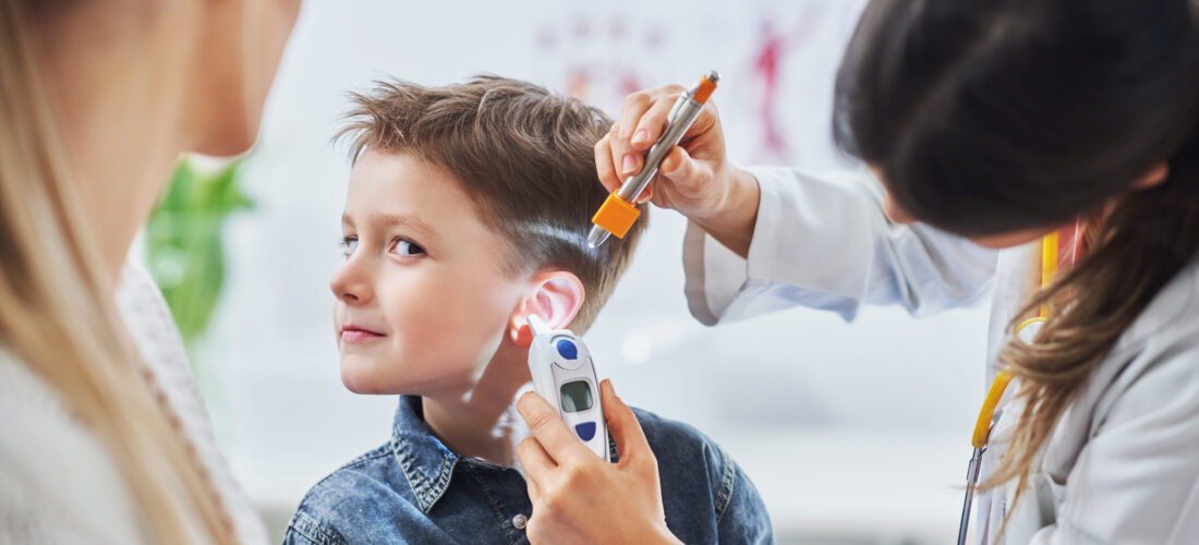 Picture of little boy having medical examination by pediatrician