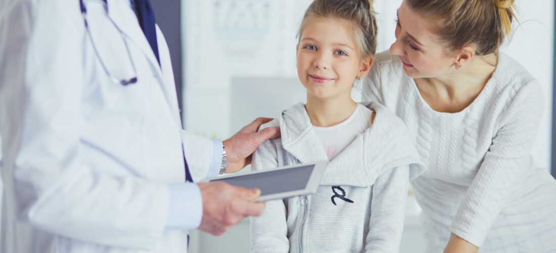 Little girl with her mother at a doctor on consultation.