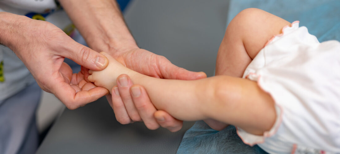 Tiny baby leg massaging. Feet massage making for child.
